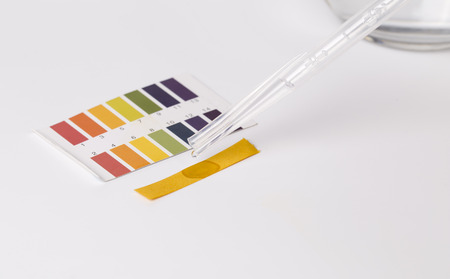 Litmus ph test and  water paper on white.の写真素材
