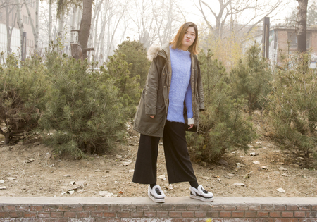 A woman standing at the roadside