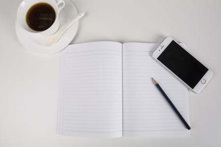 A desktop office. smart phone, coffee, notebook and pencilのeditorial素材