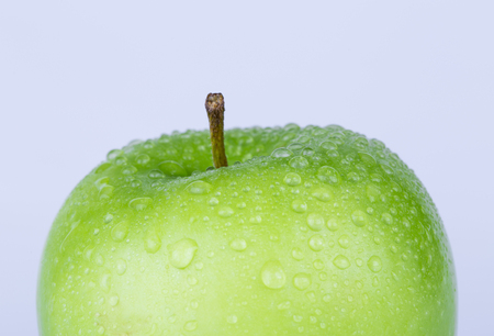 Juicy green apple's part closeup on white in studio - XXL file with selective focus.の写真素材