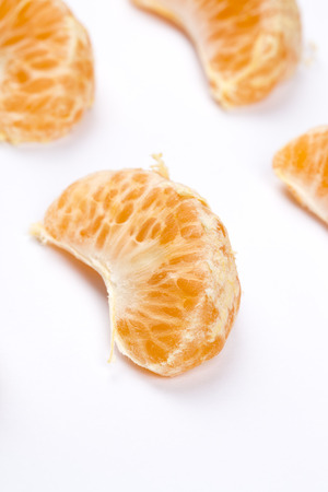 Peeled mandarin closeup isolated on white background.の写真素材