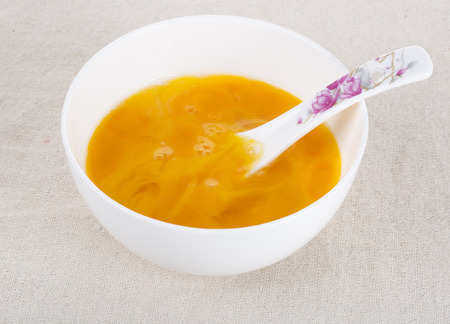 Egg yolk in white bowl on table,closeupの写真素材