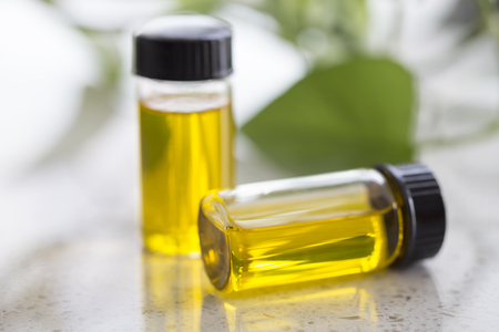 Essential oils with rose  buds on the tableの写真素材