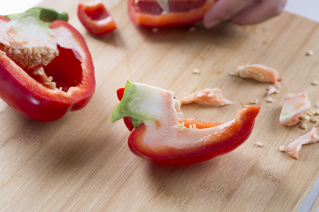 Cut Red and yellow peppers on a wooden board.の写真素材