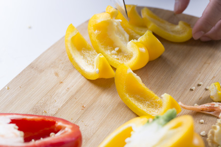 Cut vegetables on a wooden board.の写真素材