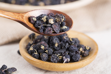 Traditional Chinese black herbs dried wolfberry close up. Black wolfberry, goji.の写真素材