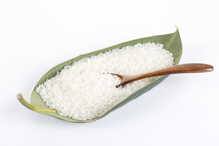 Rice grain in a green leaf on the white backgroundの写真素材