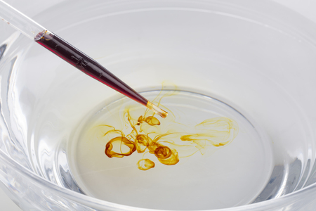 Medical supplies, dropper and iodine. Iodine drop on water surface.の写真素材