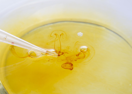Medical supplies, dropper and iodine. Iodine drop on water surface.の写真素材