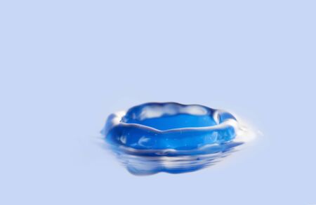 A blue water drop in photos.の写真素材