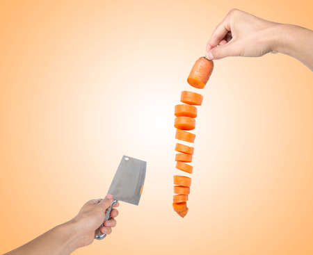 Man hand holding carrot. Cut carrot.の写真素材