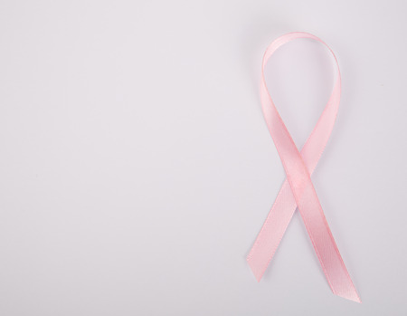 Pink breast cancer awareness ribbon on the white background.の写真素材