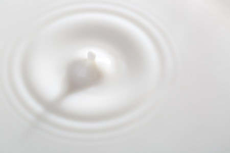 Milk or white liquid drop created ripple.の写真素材