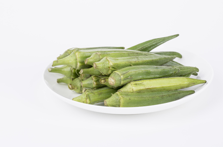 Fresh young okra on a white plate.の写真素材