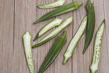 Fresh okra on the wooden table, top view.の写真素材