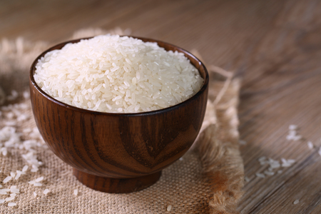 Close up of white rice in the wooden bowl.の写真素材