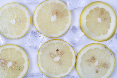 Ice cubes and lemon slices on white background.の写真素材