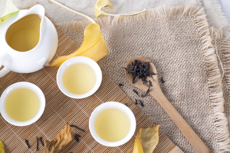 White tea cups and autumn leaves on the table. Autumn tea.の写真素材