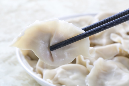 Close-Up Of Chinese Dumplings With Chopsticks.の写真素材