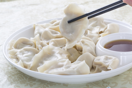 Close-Up Of Chinese Dumplings With Chopsticks.の写真素材