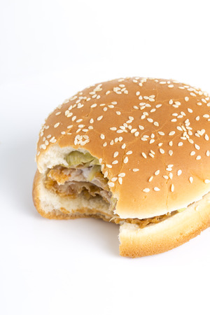 Tasty hamburger missing a bite on a white background.の写真素材