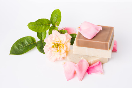 Handmade soap and fresh petals on a white backgroundの写真素材