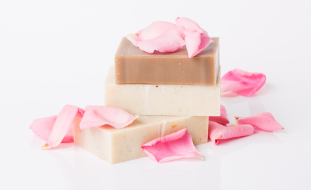Handmade soap and fresh petals on a white backgroundの写真素材