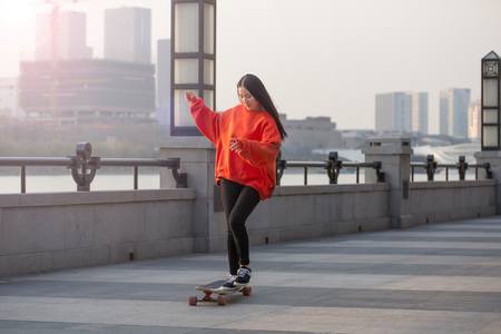 Beautiful girl is skateboardingの写真素材