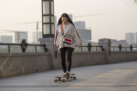 Beautiful girl is skateboardingの写真素材