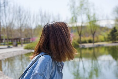 Girl student in university. Back view of young happy Asian female university studentの写真素材