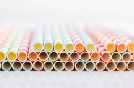 Stripped paper straws on white background