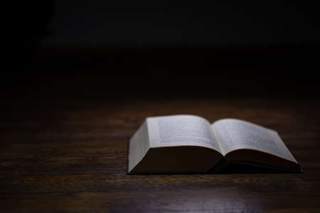 Opened book on dark background