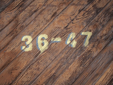 painted numbers on a old wood texture background pattern の写真素材
