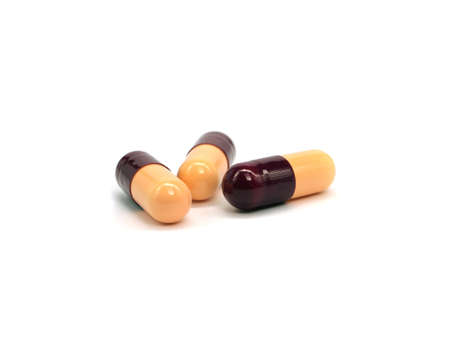 pharmaceutical capsules in glass bottle on a white backgroundの写真素材