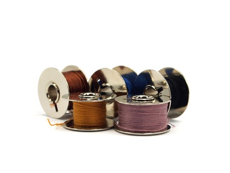 Colorful threads spools on white backgroundの写真素材