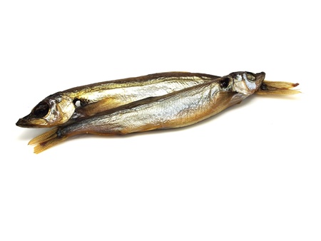 smoked capelin fish on a white backgroundの写真素材