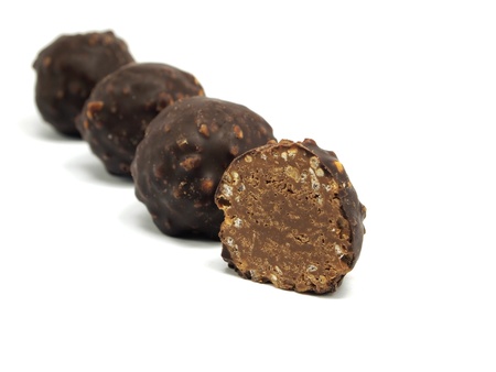sweet chocolate balls filled with hazelnuts and flips on a white background. 
の写真素材