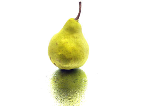 green pear on a white background with water dropsの写真素材