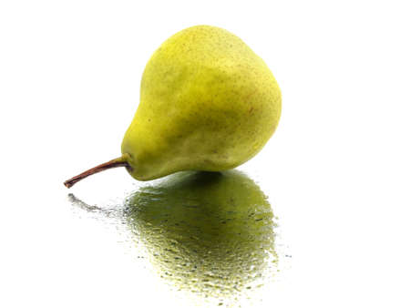 green pear on a white background with water dropsの写真素材