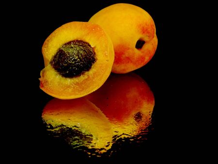 apricots on a black background with water drops 
の写真素材