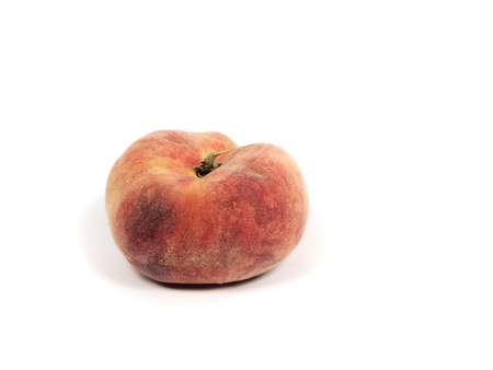 Exotic flat peach on a white backgroundの写真素材