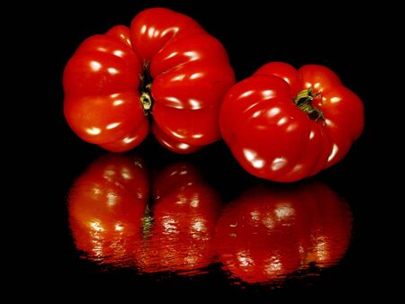 fresh organic tomatoes on a black background with water drop 
   の写真素材