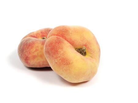 Exotic flat peach on a white backgroundの写真素材
