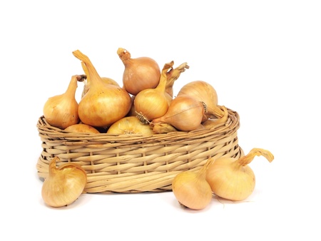 Onion bulbs on a basket on a white background. 
    の写真素材
