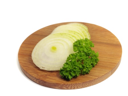 onion slices and parsley on bamboo board on a white background 
    の写真素材