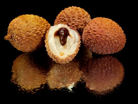 lychees on a black background with water drops 
    の写真素材