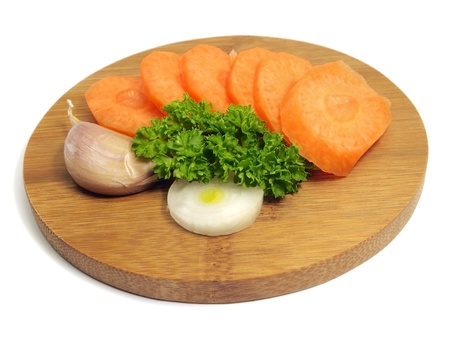 carrot slices and parsley on bamboo board on a white background 
    の写真素材