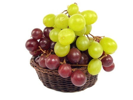 grapes in wicker basket on a white background の写真素材