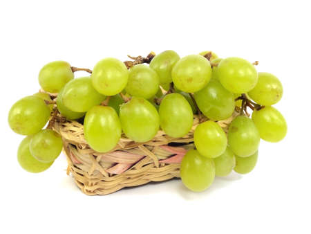 grapes in wicker basket on a white background の写真素材
