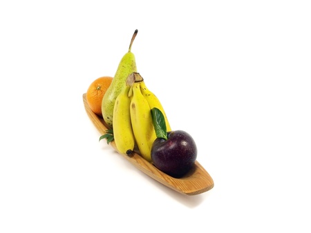 fruit in wooden plate on white backgroundの写真素材